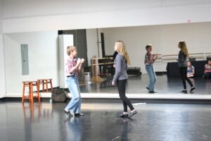 Two young women are dancing in a dance studio.