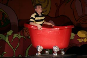 A boy in a tub on stage